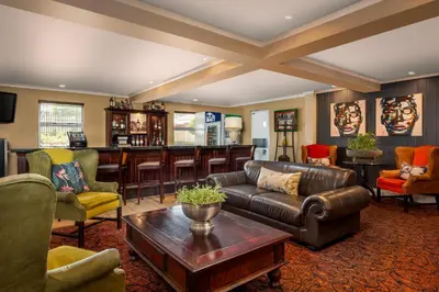 a living room with a couch and a bar at Protea Hotel by Marriott Nelspruit in Nelspruit