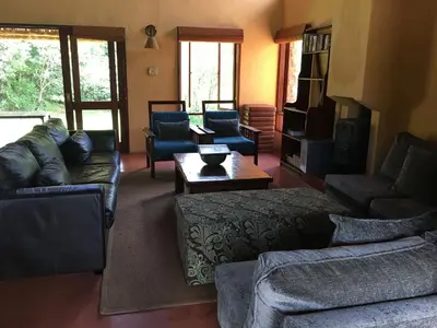 a living room with couches and a coffee table at Verlorenkloof in Dullstroom