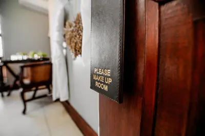 a sign on a door that reads please make up room at Opikopi Guest House in Pretoria