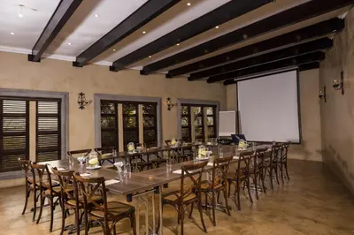 a large dining room with a long table and chairs at Opikopi Guest House in Pretoria