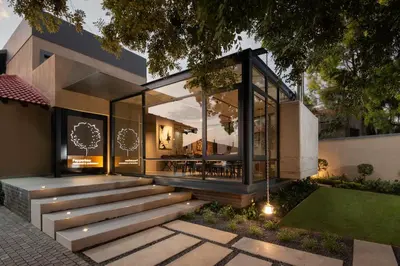 a home with a staircase and a glass house at Opikopi Guest House in Pretoria