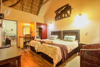 a bedroom with a large bed in a room at All over Africa Guest house in Kempton Park