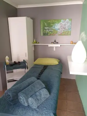 a bedroom with a bed with towels on it at PhysEQFiT Guesthouse & Spa in Centurion