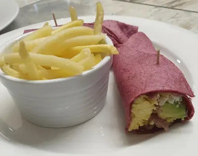 a sandwich and french fries on a white plate at PhysEQFiT Guesthouse & Spa in Centurion