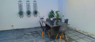 a dining room with a table with chairs and potted plants at Elsjes Guesthouse in Kempton Park