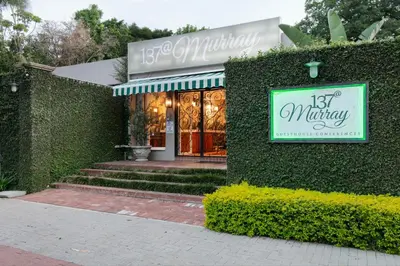 a building with a sign on the side of it at Murray Street 137 Guesthouse in Pretoria