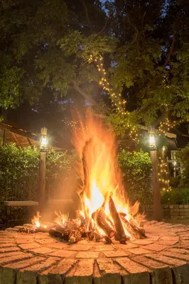 a fire pit in a park at night with lights at Murray Street 137 Guesthouse in Pretoria