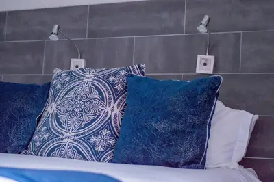a bed with two pillows on top of it at 314 on Clark Guest House in Pretoria