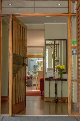 an open door into a living room with a table at 314 on Clark Guest House in Pretoria