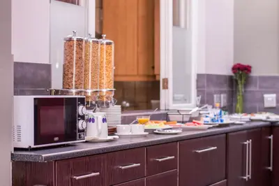 a kitchen counter with a microwave and dishes on it at 314 on Clark Guest House in Pretoria