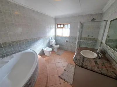 a bathroom with a tub and a sink and a toilet at Brooklyn Guesthouses in Pretoria
