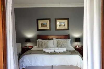 a bedroom with a bed with two towels on it at Brooklyn Guesthouses in Pretoria