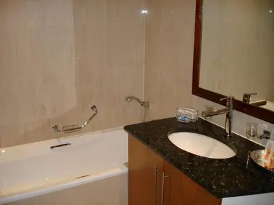 a bathroom with a sink and a mirror and a tub at Kosmos Manor Guest House in Hartbeespoort