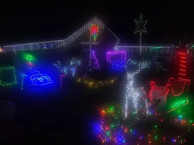a house covered in christmas lights in a yard at Apricity Inn in Louis Trichardt