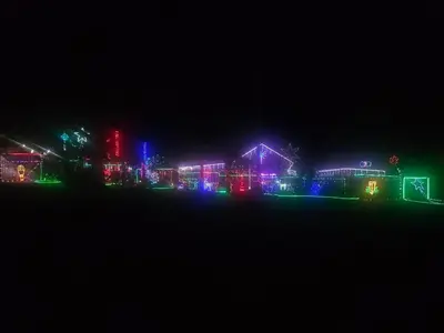 a group of houses lit up with christmas lights at night at Apricity Inn in Louis Trichardt