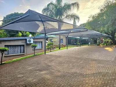 a group of umbrellas on a brick patio at Apricity Inn in Louis Trichardt