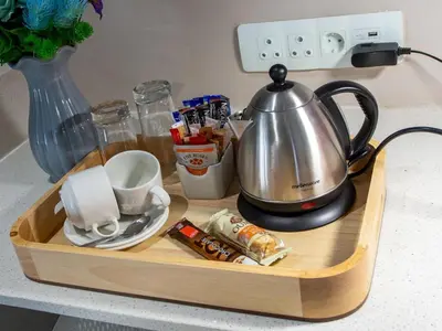 a wooden tray with a tea kettle on a counter at Global Village Guest House in Nelspruit