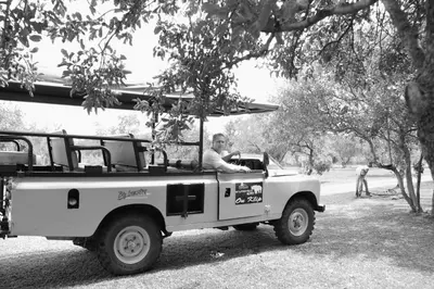 a man driving a truck in a park at OuKlip Game Lodge in Klipdrift