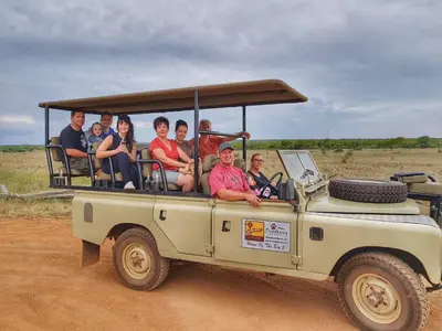 a group of people sitting in the back of a jeep at OuKlip Game Lodge in Klipdrift