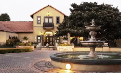 a water fountain in front of a house at Accolades Boutique Venue in Midrand