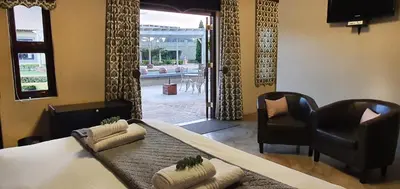 a dining room with a table and two chairs at Accolades Boutique Venue in Midrand
