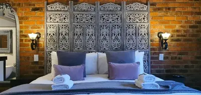 a bed with two towels on top of it at Accolades Boutique Venue in Midrand