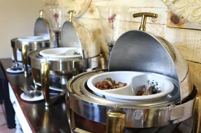 a buffet with three plates of food on a table at Accolades Boutique Venue in Midrand