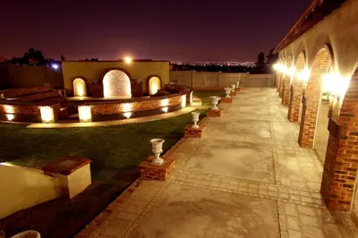 a courtyard at night with lights on a building at Accolades Boutique Venue in Midrand