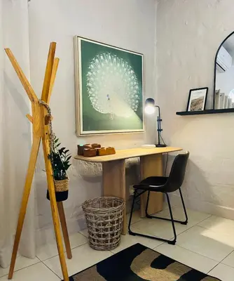 a desk in a room with a chair and a picture at Bly B&B in Pretoria