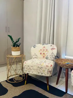 a chair and a table in a room at Bly B&B in Pretoria