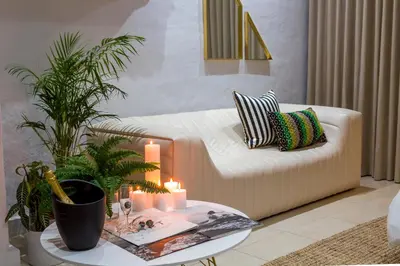 a living room with a white couch and a table at Bly B&B in Pretoria