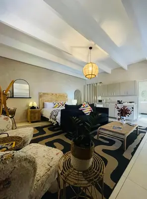 a living room with a couch and a table at Bly B&B in Pretoria