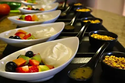 a bunch of bowls of food on a table with spoons at Abangane Guest Lodge in Hazyview
