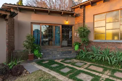 a brick house with a front door and plants at Aberfeldy Bed & Breakfast in Midrand