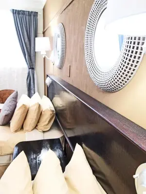 a bedroom with a bed and a mirror and pillows at Travel Lodge Sabie in Sabie