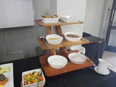 a wooden stand with bowls of food on it at Midrand Conference Centre in Midrand