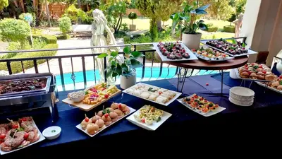 a table with many plates of food on it at Midrand Conference Centre in Midrand