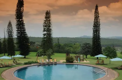 a large swimming pool with a playground and trees at Premier Hotel The Winkler in White River