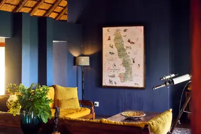 a living room with a couch and a map on the wall at Parsons House in Hoedspruit