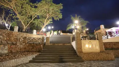 a set of stairs at night with people walking down them at African Rest Lodge in Barberton
