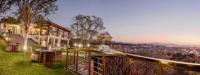 a house on a hill with a view of the city at Loerie's Call Guesthouse in Nelspruit