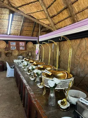 a buffet line with bowls and baskets on it at Xisaka Guest House in Giyani