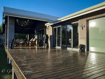 a large wooden deck on a house at Laguna Lodge in Graskop