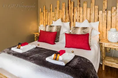 a bedroom with a bed with two pillows on it at Laguna Lodge in Graskop