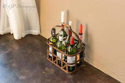 a basket of wine bottles with candles on a wall at Laguna Lodge in Graskop
