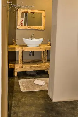 a bathroom with a sink and a mirror at Laguna Lodge in Graskop