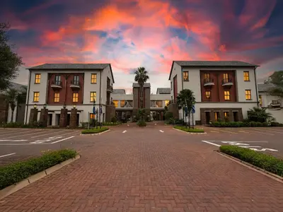 an empty parking lot in front of two buildings at Tayfin Royale Hotel & Conference Centre in Centurion