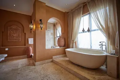 a bathroom with a large tub and a window at Tayfin Royale Hotel & Conference Centre in Centurion