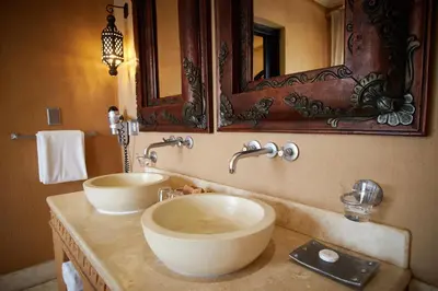 a bathroom with two sinks and a mirror at Tayfin Royale Hotel & Conference Centre in Centurion