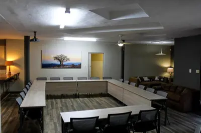 a conference room with a large table and chairs at Polo Guest House in Polokwane